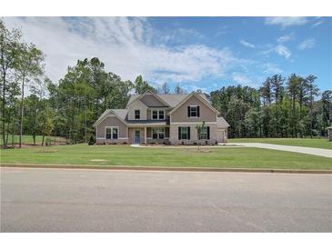 Beautiful two-story home boasts a well-manicured lawn and a charming brick and siding exterior at 30 Homesite Cooper E Cv, Fayetteville, GA 30215
