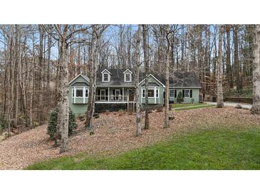 Charming green home with a well-maintained yard and mature trees offering a peaceful setting at 90 Lakeside Dr, Hiram, GA 30141