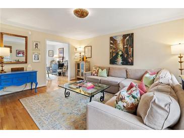Cozy living room featuring a comfortable sectional sofa, stylish glass coffee table, and bright, colorful decor at 1101 Collier Nw Rd # U6, Atlanta, GA 30318