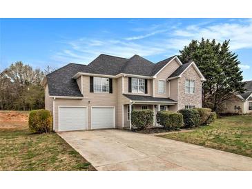Charming two-story home featuring a two-car garage and a combination of siding and stone accents at 4260 Mason Creek Rd, Winston, GA 30187