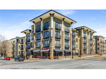 Modern apartment building featuring stylish architecture, multiple balconies, and street-level commercial spaces at 5300 Peachtree Rd # 1311, Atlanta, GA 30341
