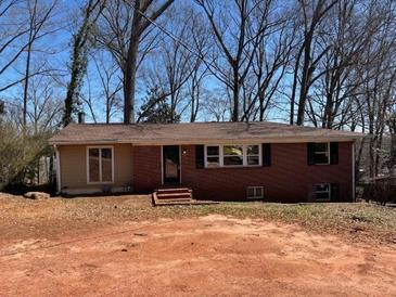 Charming single-story home with brick facade, complimented by well-placed windows and a welcoming front entrance at 542 Sugar Hill Nw Dr, Marietta, GA 30060