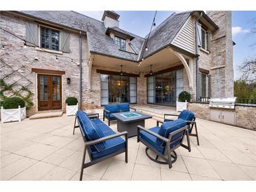 Beautiful patio with modern furniture and a fire pit, perfect for outdoor entertaining at 225 Dovecrest Dr, Atlanta, GA 30305