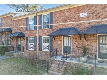 Charming brick townhomes featuring black shutters, covered entries, and well-maintained landscaping at 5629 Kingsport Dr # 11, Atlanta, GA 30342
