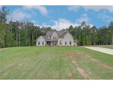 Stunning two-story home with a manicured lawn and lush surrounding greenery, radiating curb appeal at 31 Homesite Cooper E Cv, Fayetteville, GA 30214