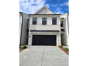 Inviting two-story home with a painted brick facade and a convenient two-car garage at 988 Sutherland Lane (Lot 33), Lawrenceville, GA 30043