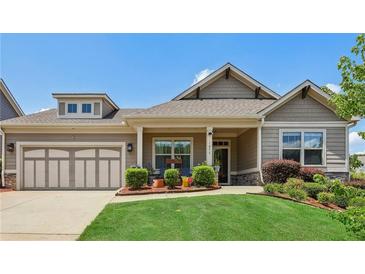 Charming single Gathering home with manicured lawn and attached two car garage at 1602 Renaissance Ne Dr, Conyers, GA 30012