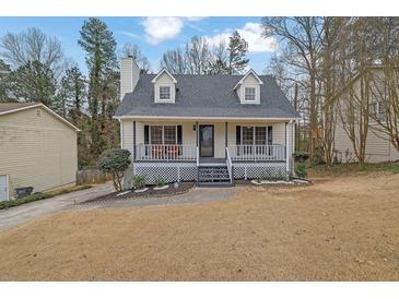 Charming home featuring a welcoming front porch and well-maintained landscaping in a suburban setting at 2520 Waterford Park Dr, Lawrenceville, GA 30044