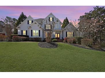 Charming two-story home with manicured lawn and mature landscaping in a suburban setting at 1023 Spruce Creek Ln, Lawrenceville, GA 30045