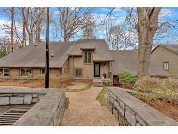 Charming home with a well-manicured yard and inviting stone walkway leading to the front door at 4144 D Youville Trce, Atlanta, GA 30341