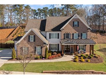 Stunning two-story brick home with a beautifully landscaped front yard and inviting covered porch at 330 Peninsula Pt, Canton, GA 30115
