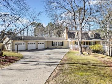 Sprawling ranch style home with a three car garage and circular drive on a large lot at 444 Pineview Dr, Canton, GA 30114