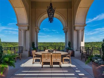 Picturesque outdoor patio with a wooden dining set surrounded by an arched colonnade and beautiful views at 3286 Northside Nw Pkwy # 304, Atlanta, GA 30327