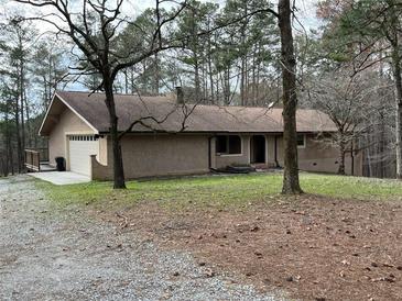 Charming single-story home with attached garage on a spacious wooded lot at 8395 Atlanta Newnan Rd, Chattahoochee Hills, GA 30268