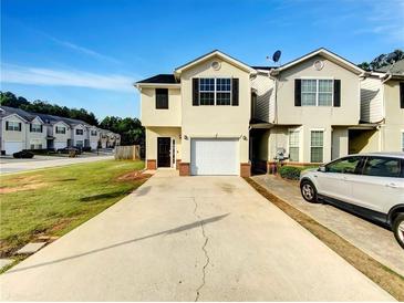 Traditional two-story home with a one car garage, black shutters, and a long driveway at 2399 Coach Way, Jonesboro, GA 30236
