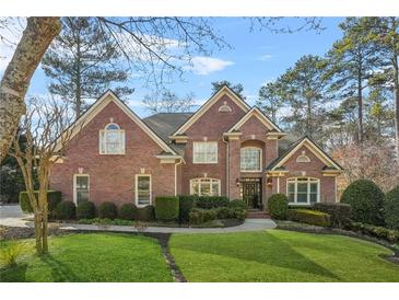 Charming brick home featuring manicured lawn and mature landscaping at 2431 Valhalla Ne Dr, Atlanta, GA 30345