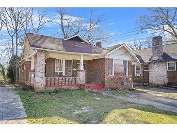 Charming brick bungalow with a covered porch and original architectural details at 732 Cascade Ave, Atlanta, GA 30310