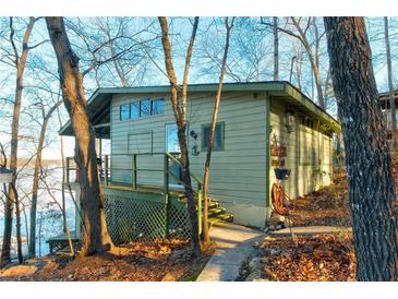 Charming lakeside cottage with a cozy porch and scenic surroundings at 5 Yachting Way, Acworth, GA 30102