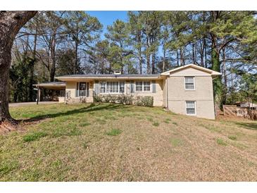 Charming brick home with a carport and well-maintained front lawn at 508 Greenridge Cir, Stone Mountain, GA 30083