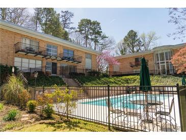 Exterior view featuring a pool, outdoor seating, and well-maintained landscaping at 1235 Woodland Ne Ave # 1, Atlanta, GA 30324