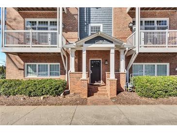 Charming brick townhouse features a welcoming entrance with white columns and private balconies at 1258 Dekalb Ne Ave # 129, Atlanta, GA 30307