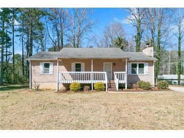 Charming single-story home with a cozy front porch and a well-maintained lawn at 37 Indian Hills Ct, Dallas, GA 30157