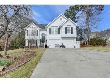 Charming two-story home boasts a well-maintained lawn, a two-car garage and classic curb appeal at 4184 Wyndham Park Way, Buford, GA 30519