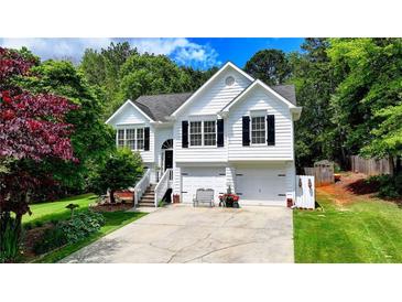 Charming two-story home with white siding, black shutters, and a well-manicured front yard at 4184 Wyndham Park Way, Buford, GA 30519