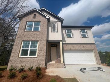 Two-story home boasts a brick facade, attached garage, and a welcoming entrance at 630 Gilles Ln, Cumming, GA 30041