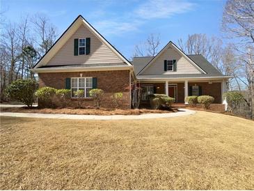 Charming one-story brick home with green shutters and well-maintained landscaping at 9585 Grande Dr, Winston, GA 30187