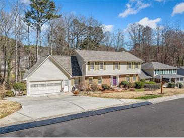 Charming two-story home featuring a spacious driveway, two-car garage, and well-maintained landscaping at 1532 Boxwood Nw Trce, Acworth, GA 30102