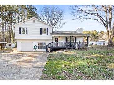 Charming split-level home showcasing a welcoming front porch and well-maintained front yard at 916 Marshall Fuller Rd, Dallas, GA 30157