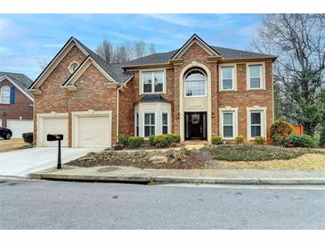 Charming two-story brick home with well-manicured landscaping and attached two-car garage at 2730 Henderson Chase Ct, Tucker, GA 30084