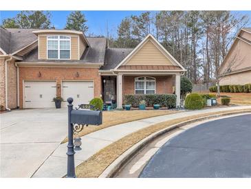 Charming brick home featuring a two-car garage and well-manicured landscaping at 498 Townsend St, Grayson, GA 30017