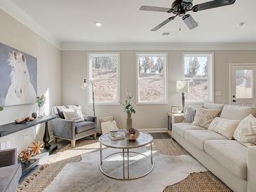 Bright living room with stylish decor, ceiling fan, and plenty of natural light at 4531 Moray Dr, Mableton, GA 30126