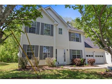 Charming two-story home with vinyl siding, gray shutters, landscaped yard, and an attached two car garage at 4832 Hidden Creek Pl, Decatur, GA 30035