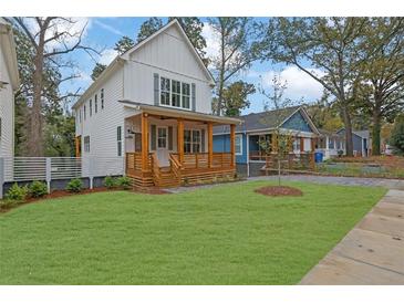 Charming two-story home with a well-manicured lawn and inviting wooden porch at 830 Gaston Street Sw, Atlanta, GA 30310