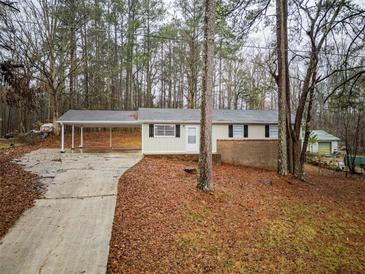 Charming single-story home with carport and mature trees at 3564 Sage Dr, Lithia Springs, GA 30122