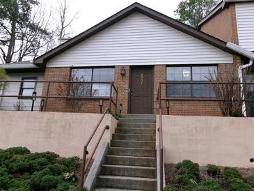 Inviting front entrance features a brick facade, concrete stairs, and landscaping at 6051 Wintergreen Rd, Norcross, GA 30093