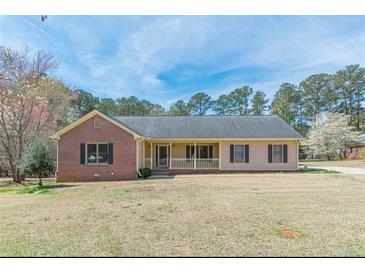 Charming single-story home featuring a brick facade, covered porch, and well-maintained lawn at 110 Eastfield Ct, Mcdonough, GA 30252