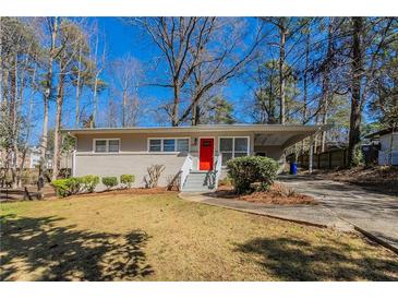 Charming ranch home featuring a brick facade, bright red front door, and covered carport at 1584 Belva Ave, Decatur, GA 30032