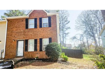Two-story brick home with black shutters and a well-maintained lawn at 5582 Windwood Rd, Atlanta, GA 30349