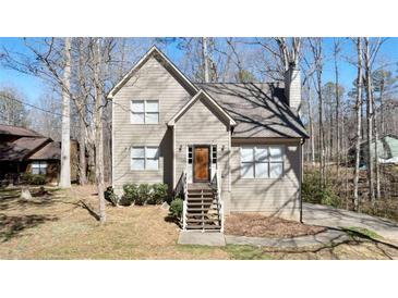 Charming home featuring a welcoming front porch and classic architectural details, nestled in a wooded setting at 108 Kelly Ct, Dallas, GA 30157