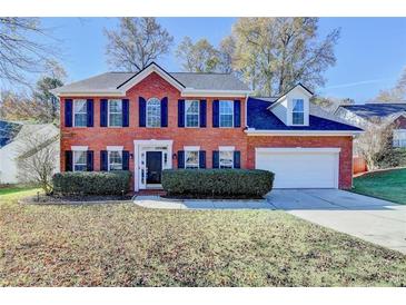 Charming two-story brick home with manicured landscaping and an attached two-car garage at 2697 Links Overlook Drive Dr, Dacula, GA 30019