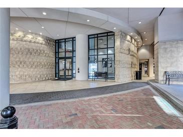 Elegant building entrance featuring textured stone walls, floor-to-ceiling windows and red-brick walkway at 3040 Peachtree Nw Rd, Atlanta, GA 30305