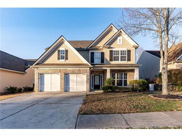 Charming two-story home with a two-car garage and well-maintained landscaping at 2496 Gristhaven Ln, Buford, GA 30519