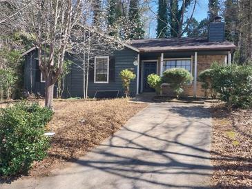A charming one-story home with a well-maintained front yard and a paved driveway at 4952 Isle Royal Ct, Stone Mountain, GA 30088