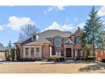 Beautiful brick home with a well-manicured lawn and mature trees, perfect for a Gathering at 2046 Chambord Way, Snellville, GA 30078