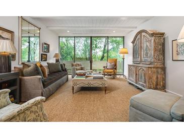 Bright living room with a large window, offering an inviting space with ample seating and natural light at 2575 Peachtree Ne Rd # 8D, Atlanta, GA 30305