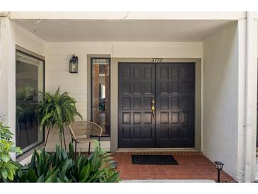 Inviting front entryway with double doors, a decorative lantern, and well-maintained landscaping at 3772 Paces Ferry West Se, Atlanta, GA 30339